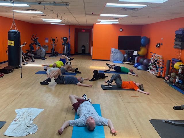 RSF group class members stretching together at the end of a session